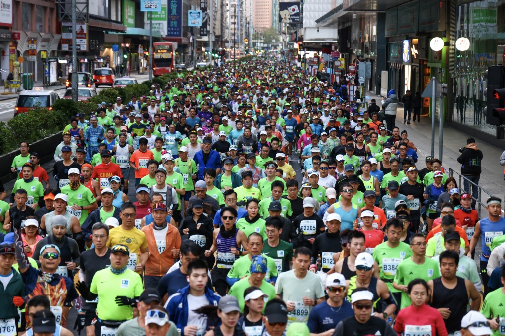 Runners pass through Mong Kok during the 2025 Standard Chartered Hong Kong Marathon. Photo: Dickson Lee