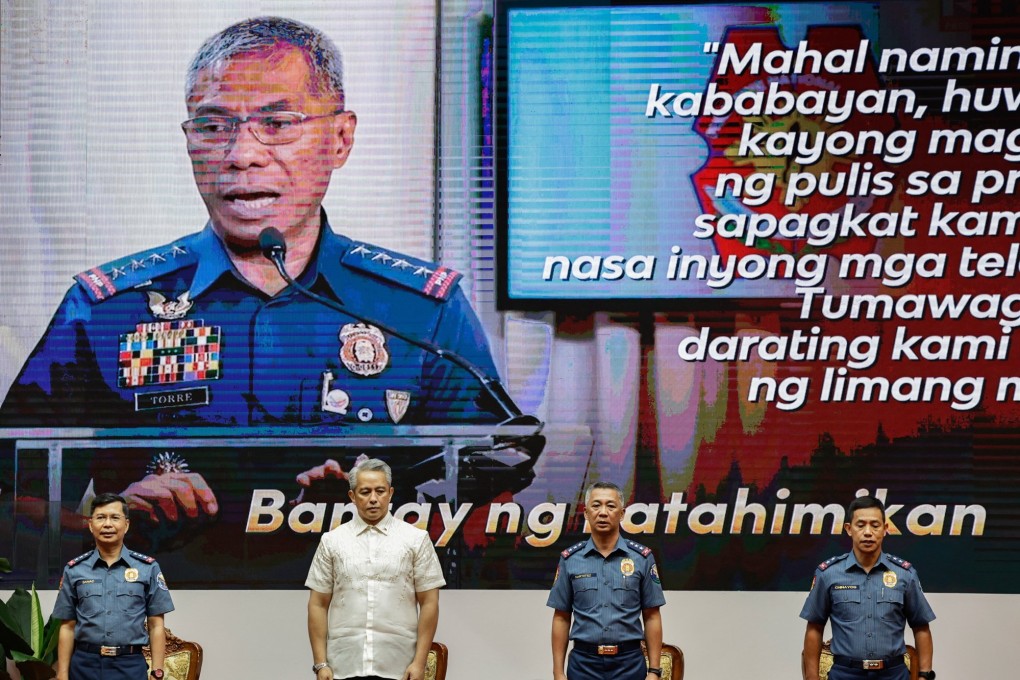 Philippine Interior Secretary Juanito Remulla (second left) and incoming police officer-in-charge Lieutenant General Jose Nartatez (third left) stand in front of an image of outgoing chief General Nicolas Torre III during a change-of-command ceremony at Camp Crame in Quezon City on Tuesday. Nartatez replaces Torre, who served just over two months. Photo: EPA