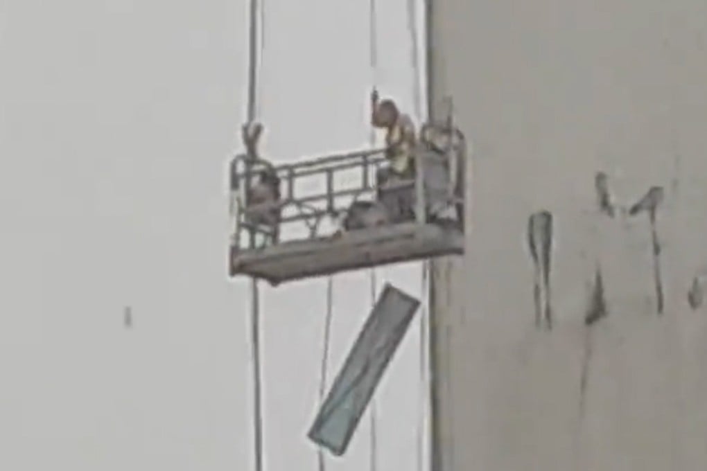 Construction workers trapped mid-air as rainstorm hits China