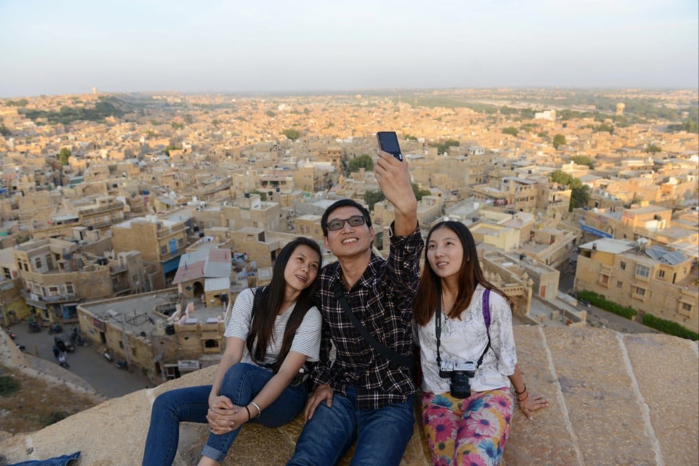 Chinese tourists take a selfie photograph at the ancient Golden Fort of Jaisalmer on Trikuta Hill in the state of Rajasthan, India. Photo: AFP