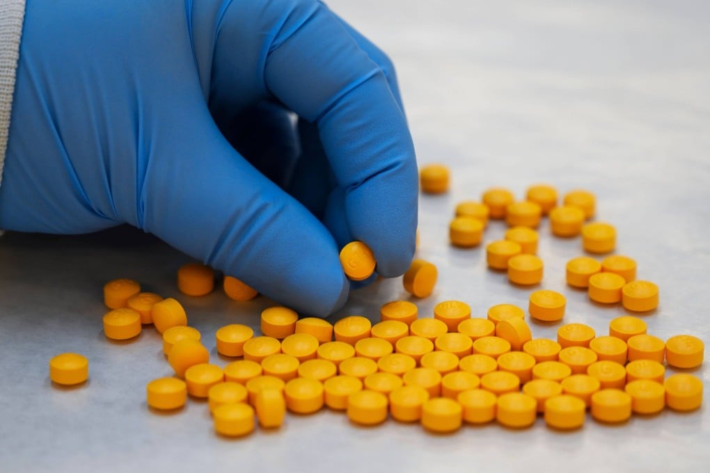 A Drug Enforcement Administration chemist checks confiscated pills containing fentanyl. Photo: AFP