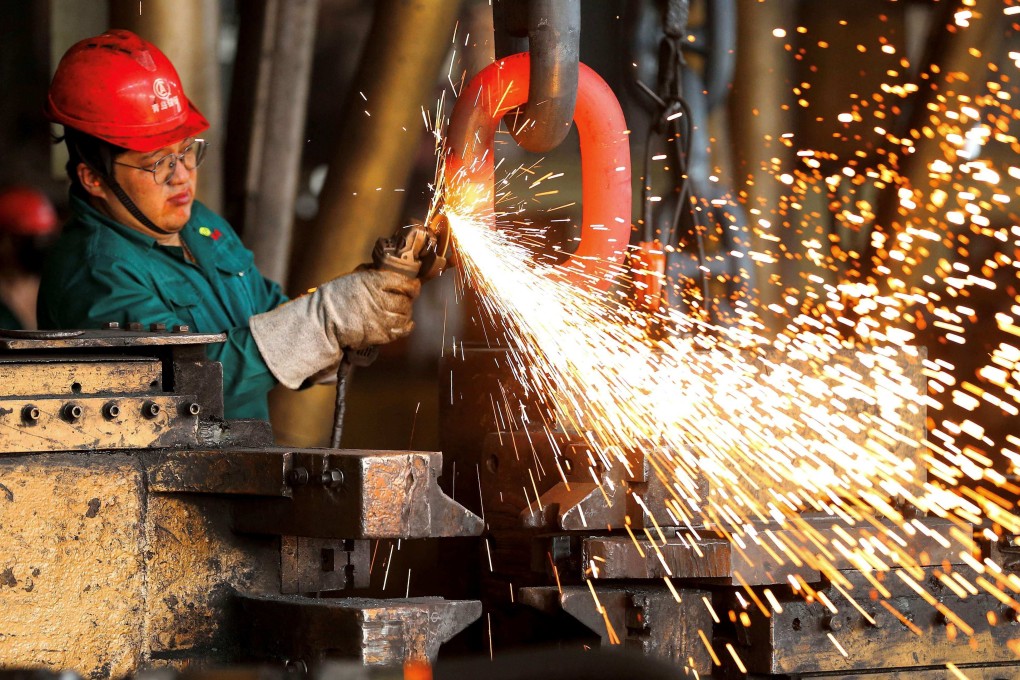 A worker welds a chain at the export production workshop of the anchor chain industrial park in Qingdao’s Jimo district on Monday. Photo: AFP