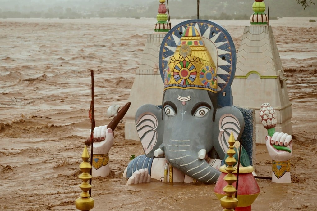 Water from the overflowing Tawi River floods a temple of the Hindu elephant god Ganesh, the deity of prosperity, following heavy rain in Jammu, Indian Kashmir on Tuesday. Photo: Reuters
