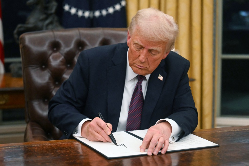 US President Donald Trump signs an executive order in the Oval Office. Trump has vowed to take action against countries that target US tech companies with digital taxes and digital services legislation. Photo: TNS