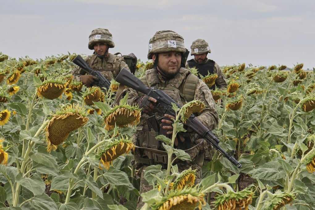 Ukrainian recruits training in a sunflower field in the Zaporizhzhia region, Ukraine. Photo: Ukraine’s 65th Mechanized Brigade via AP