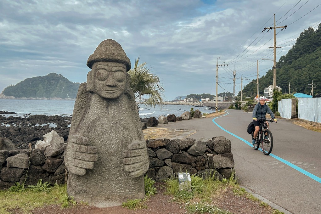 A cyclist follows the blue line that marks the Jeju Fantasy Bicycle Path, which circumnavigates the South Korean island. Photo: Cameron Dueck