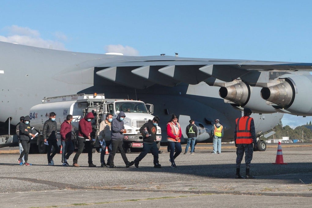 Guatemalan migrants descend from a US military plane after being deported from the US at the Guatemalan Air Force Base in January.
Photo: Guatemalan Migration Institute/AFP
