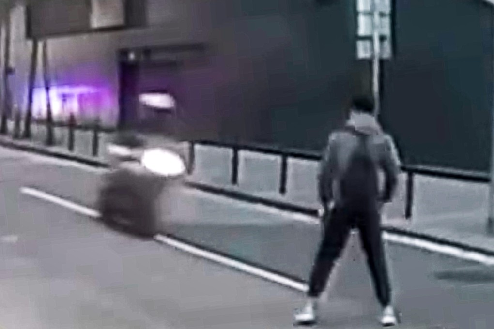 Dashcam footage shows the off-duty officer standing in the middle of the road as the biker approaches. Photo: Handout