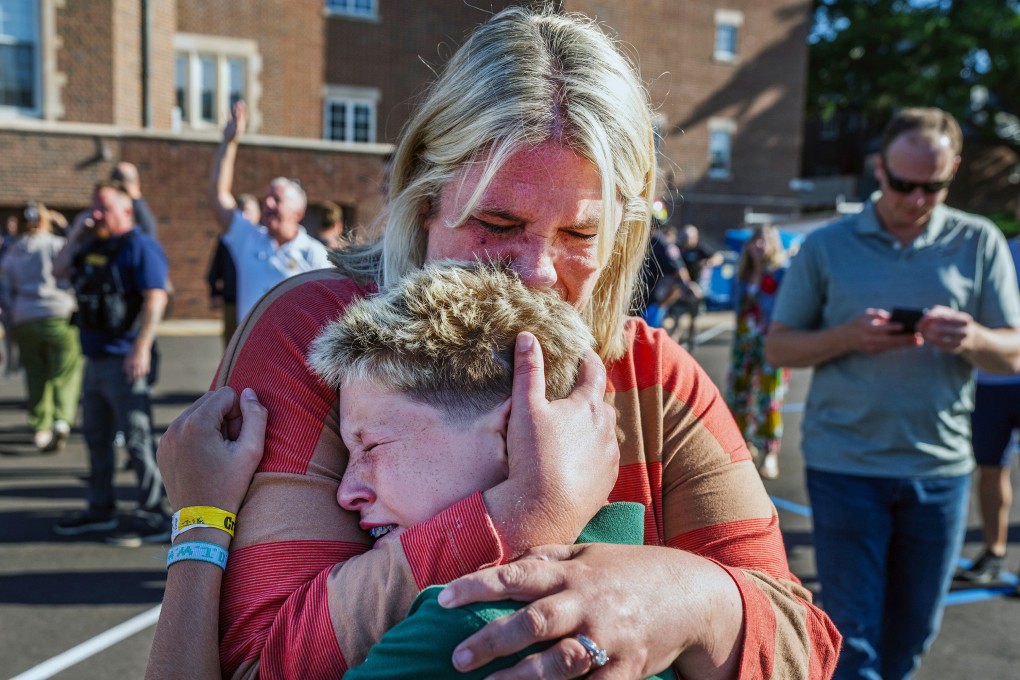 A parent hugs her son during an active shooter situation at the Annunciation Church in Minneapolis, Minnesota, on Wednesday. Photo: Star Tribune via AP