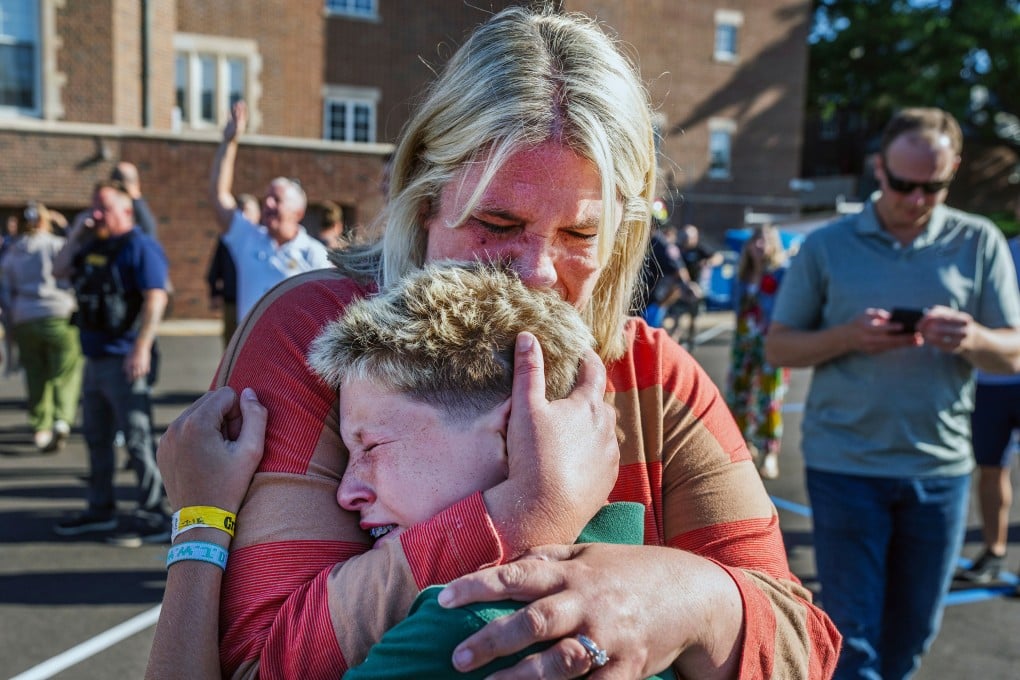 A parent hugs her son during an active shooter situation at the Annunciation Church in Minneapolis, Minnesota, on Wednesday. Photo: Star Tribune via AP