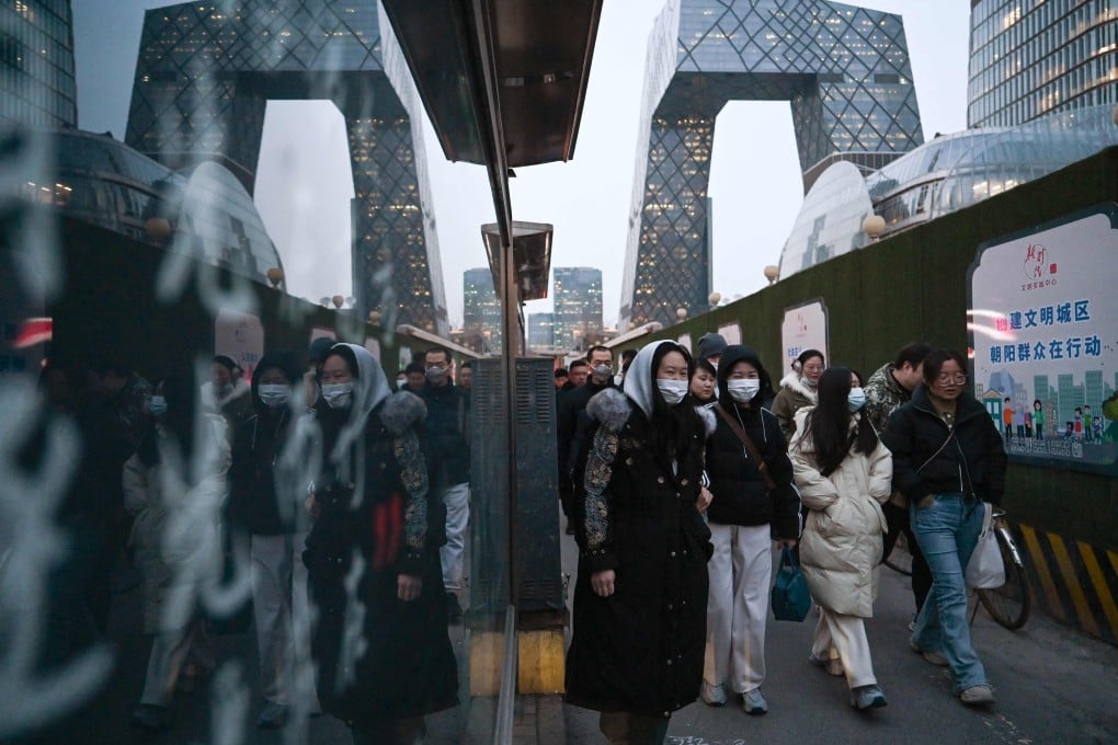 People walk through Beijing’s central business district. Photo: AFP