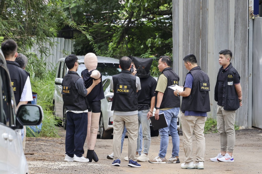 Police have arrested 15 people in connection with the 51-year-old man’s murder. Pictured is a suspect being shown a dummy representing the victim in the case. Photo: Jelly Tse