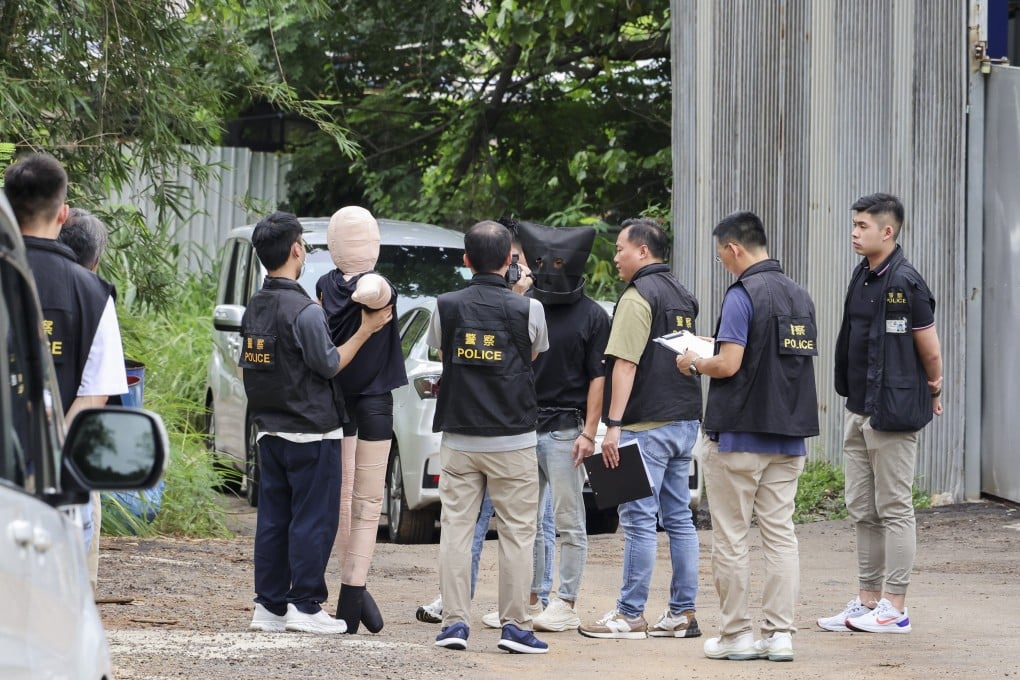 Police have arrested 15 people in connection with the 51-year-old man’s murder. Pictured is a suspect being shown a dummy representing the victim in the case. Photo: Jelly Tse