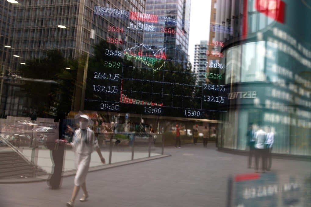 A screen shows stock exchange and economic data in Beijing on August 12. Photo: EPA