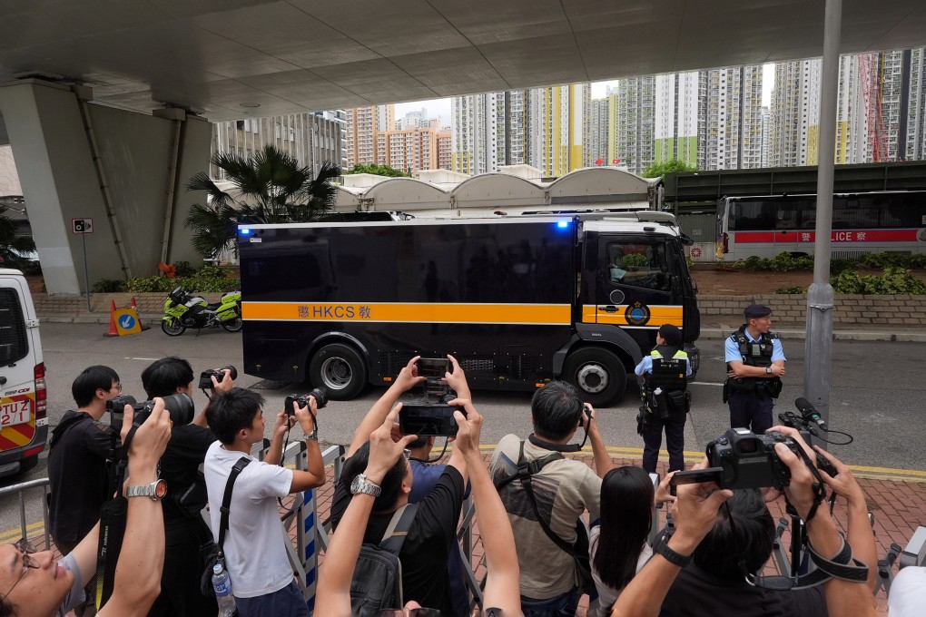 A vehicle carrying Jimmy Lai is escorted by police officers to West Kowloon Court. Photo: Elson Li