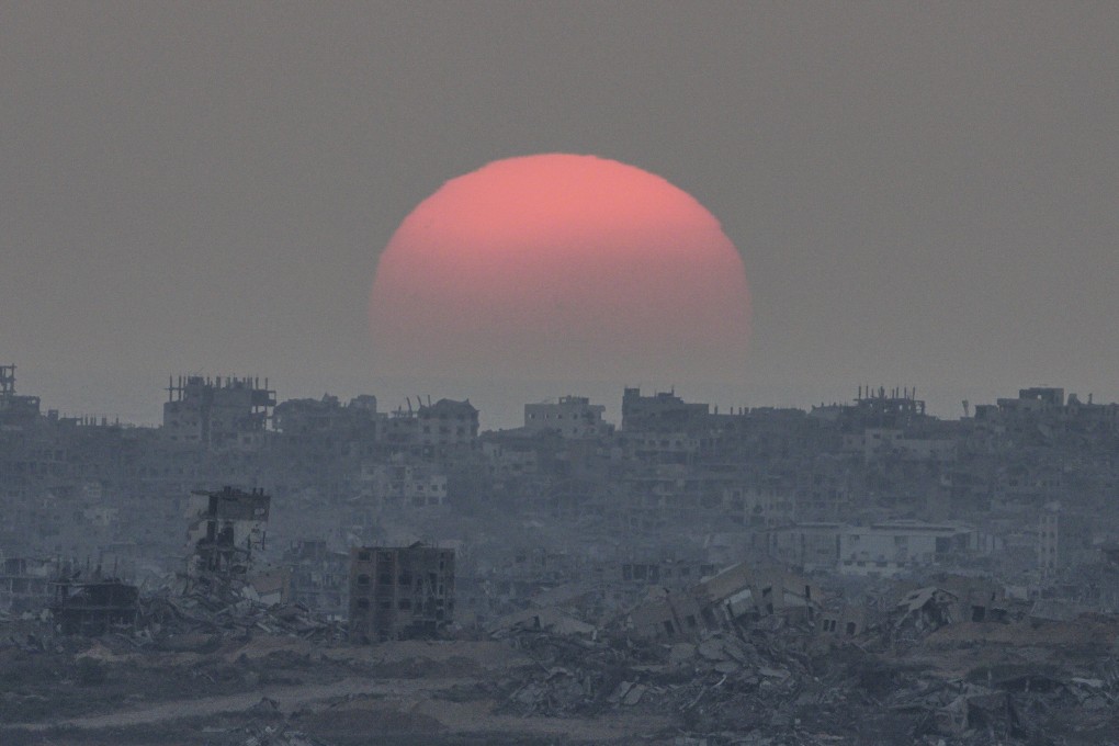 The sun sets behind buildings destroyed during Israeli ground and air operations in the Gaza Strip on Tuesday. Photo: AP