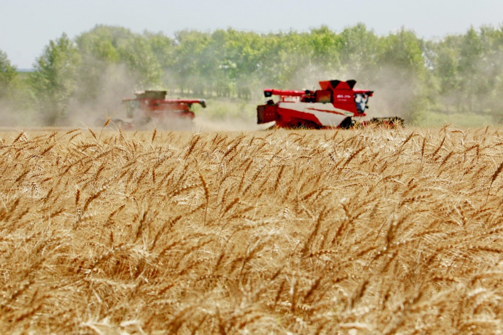 Combine harvesters plough through wheat in the field in Heihe, in northeast Heilongjiang province, on August 5. Ensuring grain supplies and food security has been a primary goal of the Communist Party for decades. Photo: Xinhua