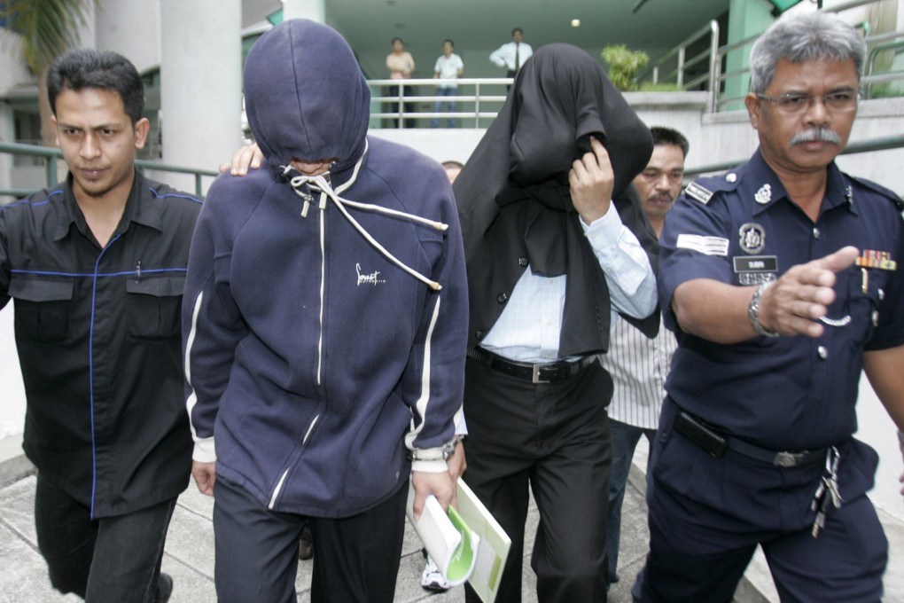 Azilah Hadri and Sirul Azhar Umar arrive at the courthouse in Shah Alam outside Kuala Lumpur in 2009. Photo: Reuters