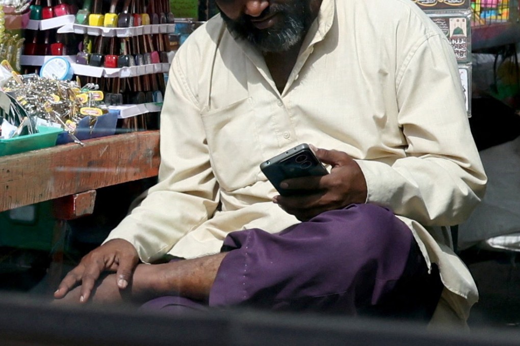 A man uses his mobile phone at a market in Bengaluru, India, last month. Photo: Reuters