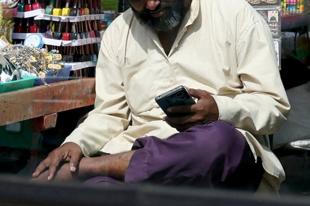 A man uses his mobile phone at a market in Bengaluru, India, last month. Photo: Reuters
