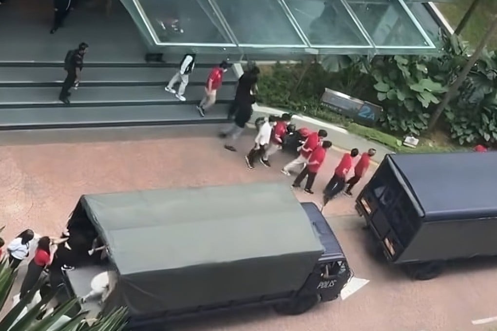 A still from footage shared on social media shows people being loaded into the back of police vans in Bangar South, Malaysia, on Tuesday. Photo: Facebook