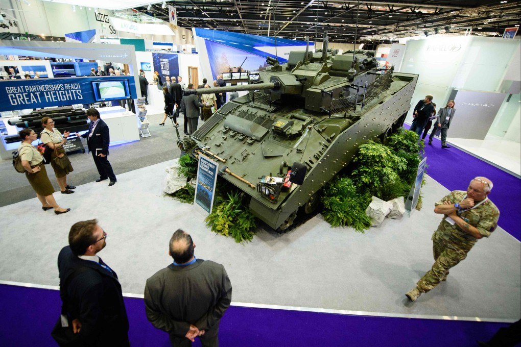 Visitors look at an armoured vehicle displayed in London during the Defence and Security Equipment International arms fair. Photo: AFP