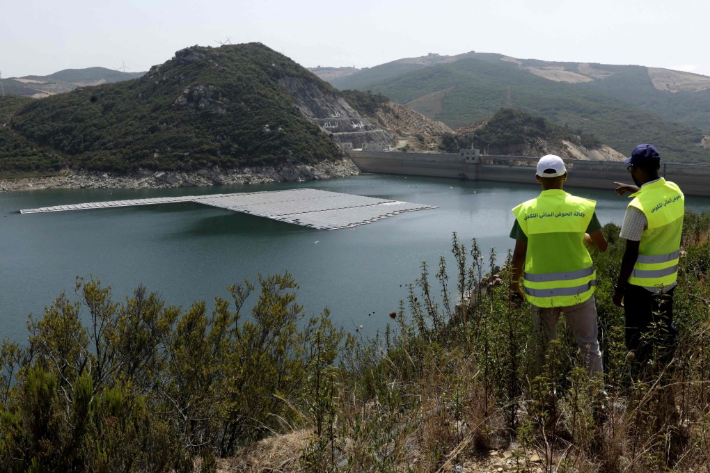 Workers inspect a floating photovoltaic solar installation on the Oued Rmel dam near the city of Tangiers in Morocco. Photo: AFP