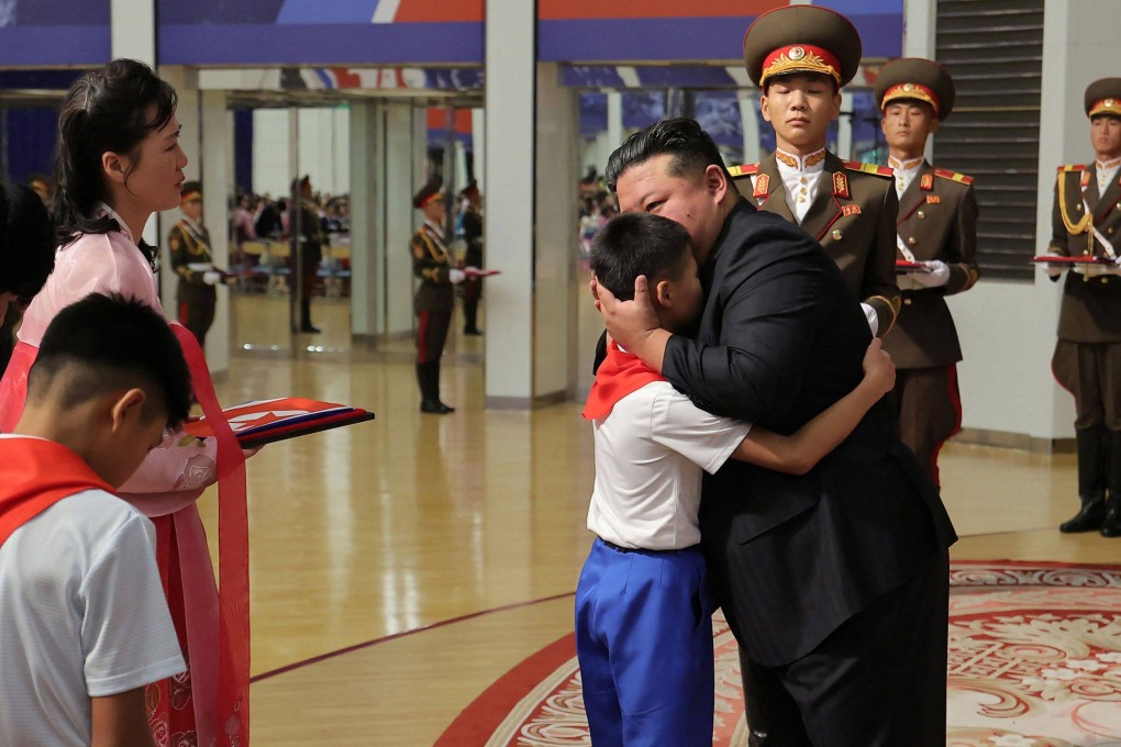 North Korean leader Kim Jong-un embraces a family member of a soldier killed overseas at an event in Pyongyang on Friday honouring the fallen. Photo: KCNA/KNS/AFP