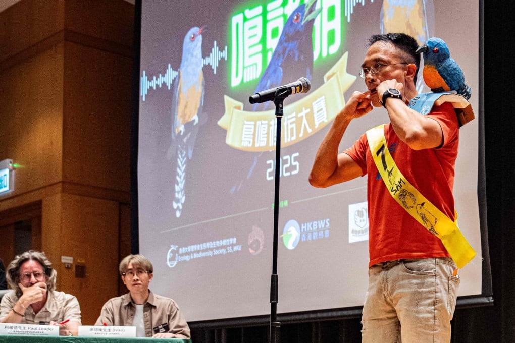 A participant, wearing a bird-themed decoration, mimics bird calls during the Hong Kong Bird Watching Society’s bird call competition at the University of Hong Kong on August 23. Photo: AFP