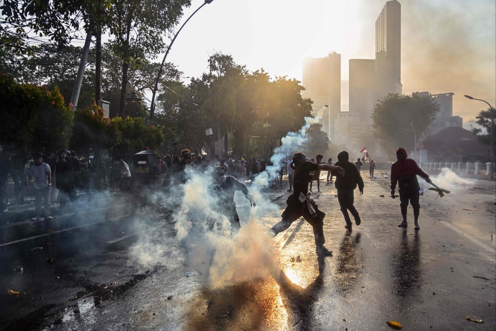 Police fire tear gas to disperse protesters in Jakarta on Friday after the death of a motorbike taxi driver the previous night. Photo: AFP