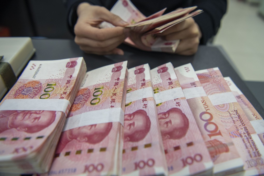 An employee counts yuan at a bank in Haian, China. Photo: Getty Images