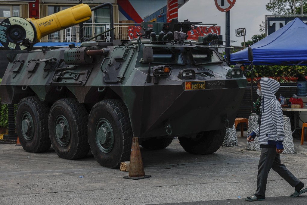 A man walks past an army armoured vehicle parked outside a shopping mall in Jakarta on Monday. Photo: EPA