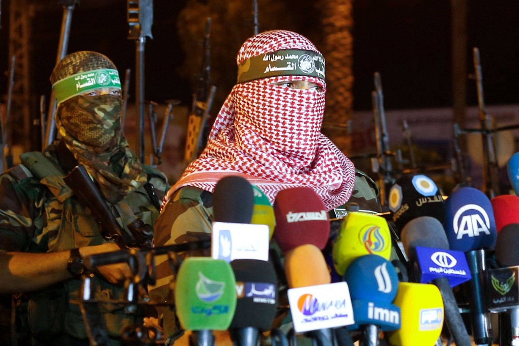 Abu Obeida, right, spokesman for Hamas’ armed wing the Qassam Brigade in Gaza City on July 8. Obeida was killed at the weekend, the Israeli military said on Sunday. Photo: AFP