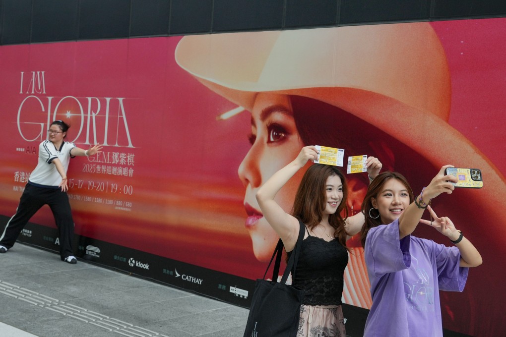 Fans strike a pose in front of a poster at Kai Tak Sports Park on August 15, just ahead of the concert that night by singer Gloria Tang Tsz-kei, known as G.E.M. Photo: May Tse