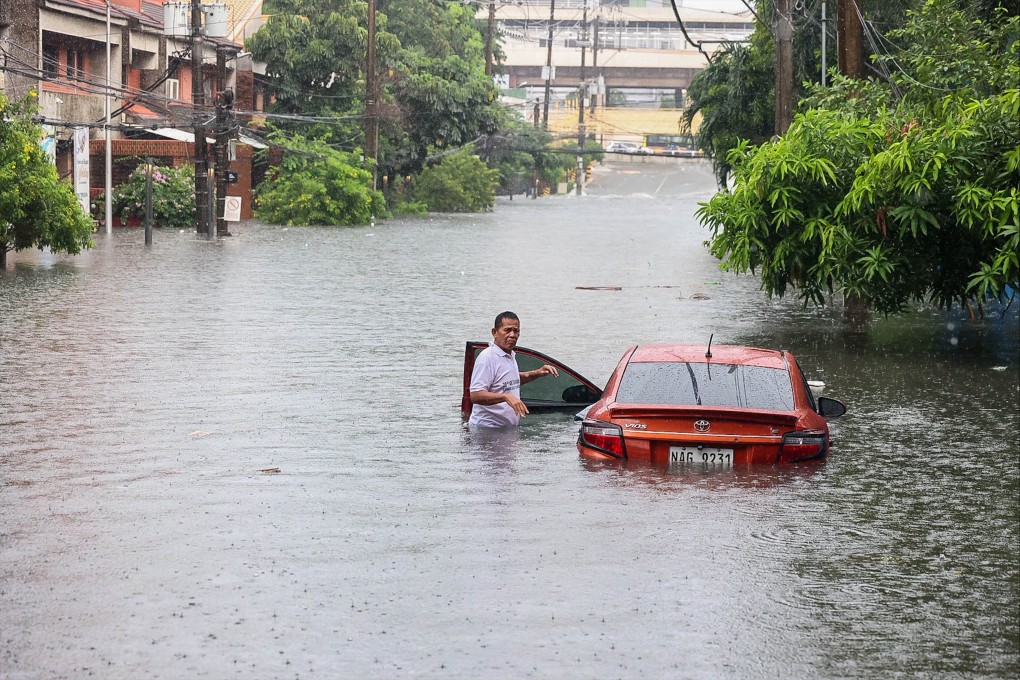 A car is seen partially submerged in floodwater during heavy rain in Quezon City, the Philippines, on Saturday. Photo: Xinhua