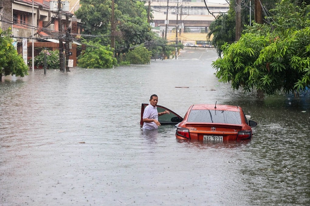 A car is seen partially submerged in floodwater during heavy rain in Quezon City, the Philippines, on Saturday. Photo: Xinhua