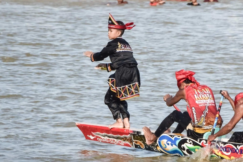 Rayyan Arkan Dikha, 11, dances on the bow of his team’s longboat during the Pacu Jalur river race in Sumatra’s Riau Province. Attendance at this year’s event, which dates back to the 17th century, is estimated to have swelled by more than 100,000 after a video of the boy’s moves garnered millions of views on social media. Photo: AFP
