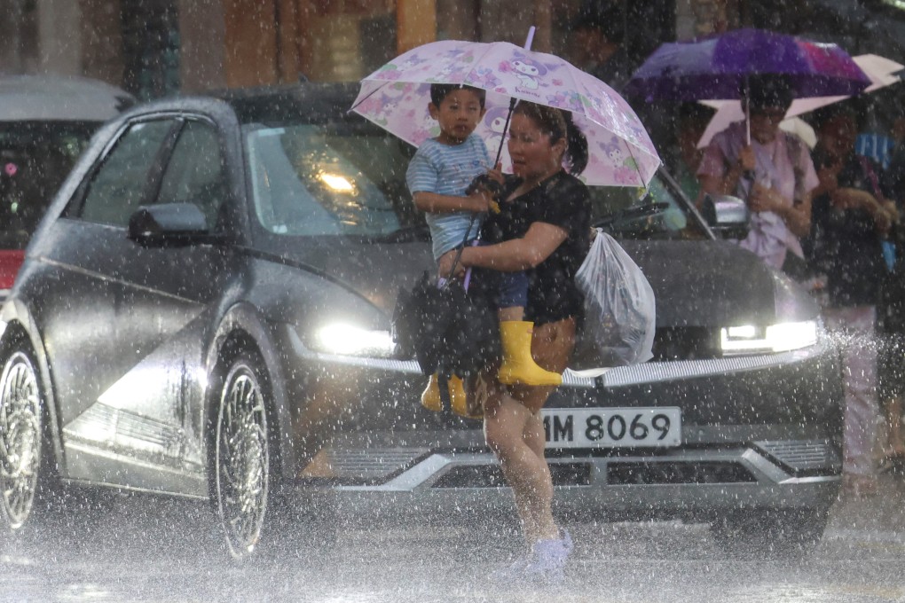 Pedestrians brave the heavy rain in Jordan on August 19. Photo: Jelly Tse
