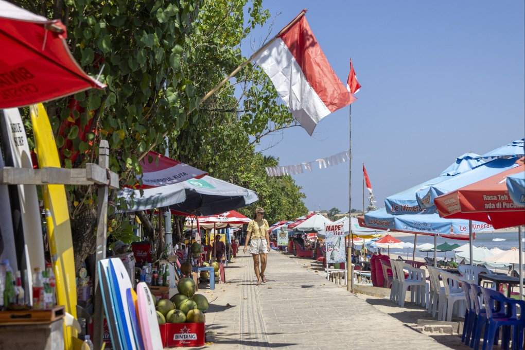 A tourist walks along Kuta beach in Bali, Indonesia, on Tuesday. Tourism leaders and Bali officials have assured travellers that the island is safe to visit. Photo: EPA