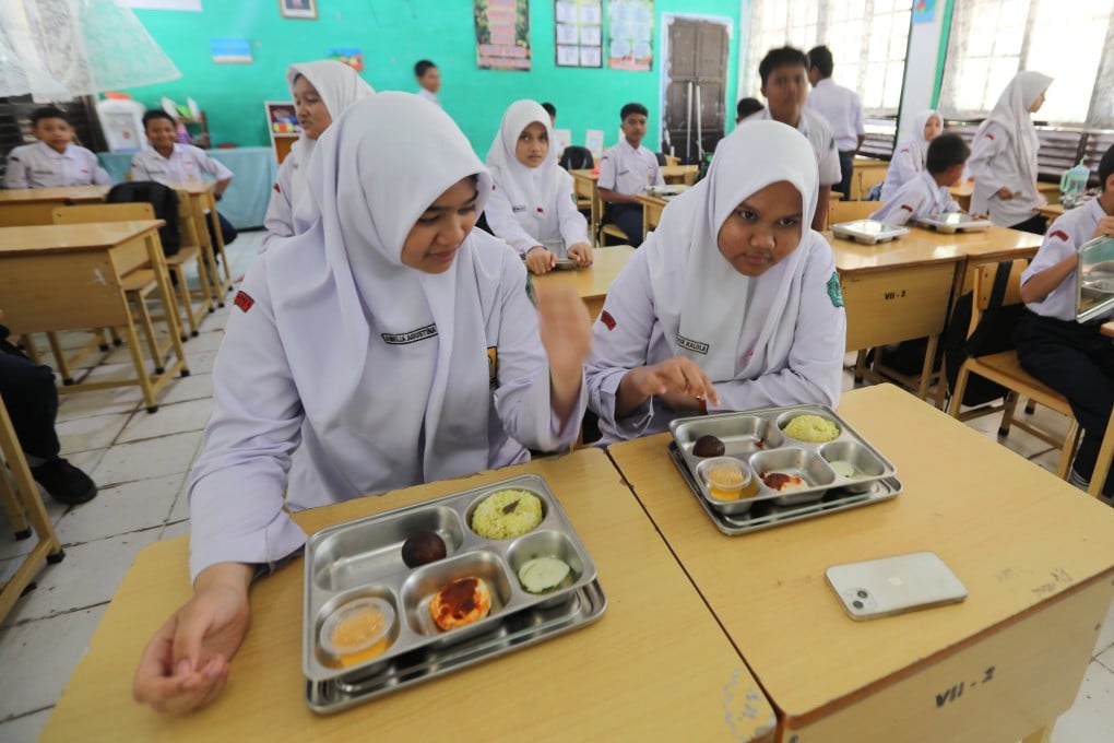 Indonesian students consume their free meals at a school in Banda Aceh, Indonesia in August. Photo: EPA