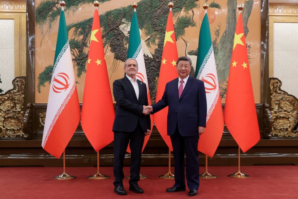 Iranian President Masoud Pezeshkian and Chinese President Xi Jinping shake hands on Monday in Beijing. Photo: Reuters