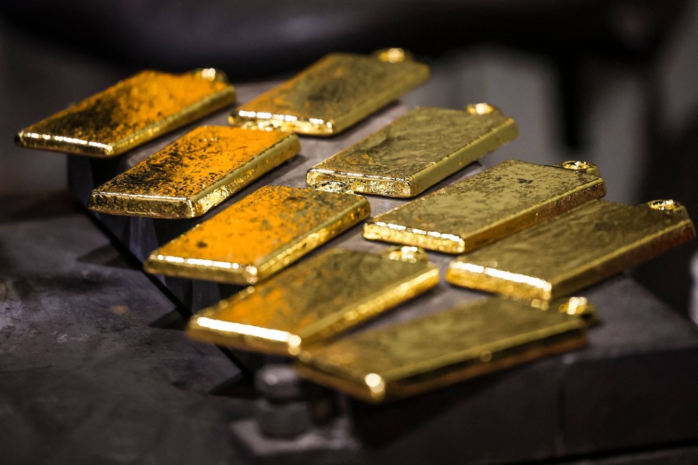 Gold bullion can be seen after being removed from casts at the ABC Refinery smelter in Sydney. Photo: AFP