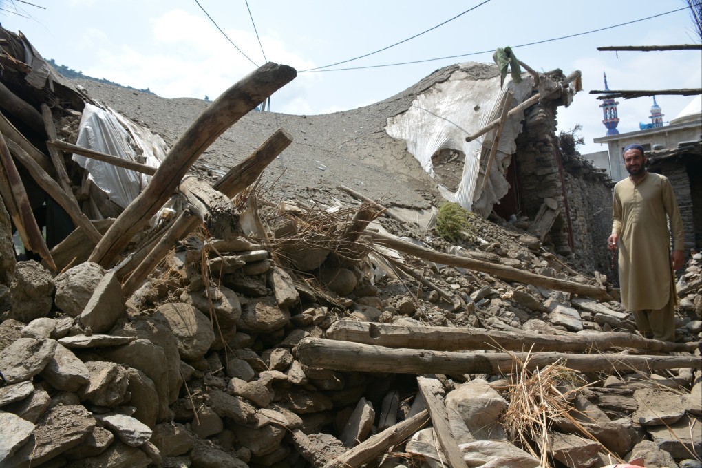 A man stands among the rubble of damaged houses on Tuesday after an earthquake in Afghanistan. Photo: EPA