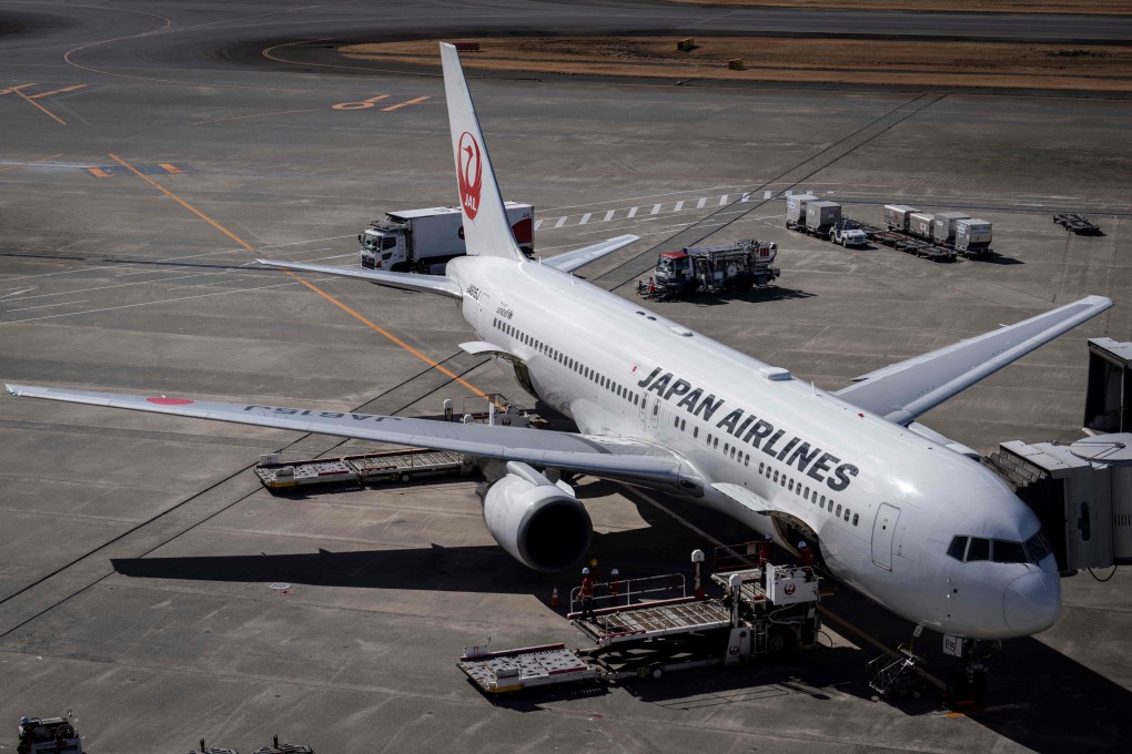 A Japan Airlines passenger plane sits on the tarmac at Haneda Airport in Tokyo. Photo: AFP