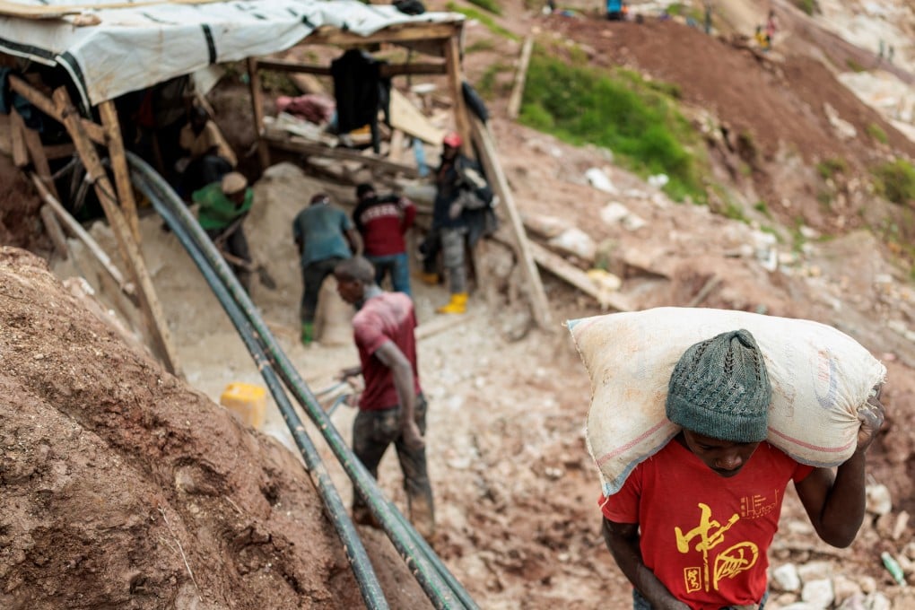 A labourer carries a sack of ore at the Rubaya coltan mine in the Democratic Republic of Congo on March 24. Photo: Reuters