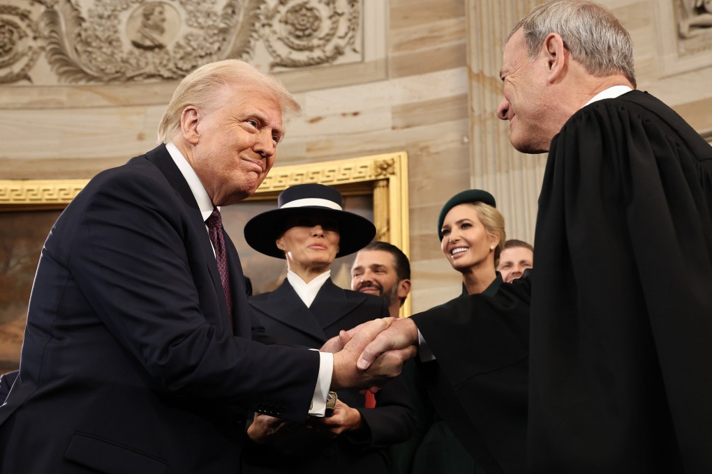 US President Donald Trump shakes hands with US Supreme Court Chief Justice John Roberts during inauguration ceremonies in the Rotunda of the US Capitol in Washington on January 20. Photo: Getty Images