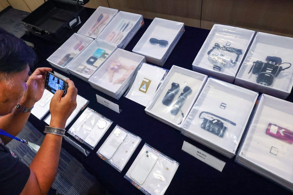 Immigration authorities display some of the items confiscated from the illegal mainland Chinese workers who provided unlicensed photography and make-up services in Hong Kong. Photo: Dickson Lee