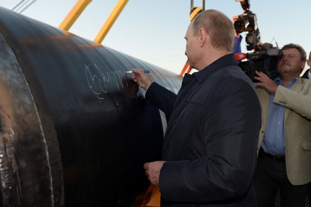 Russias President Vladimir Putin signs on the first segment of the Power of Siberia pipeline during a ceremony at the village of Us Khatyn in Russia on September 1, 2014. Photo: Reuters