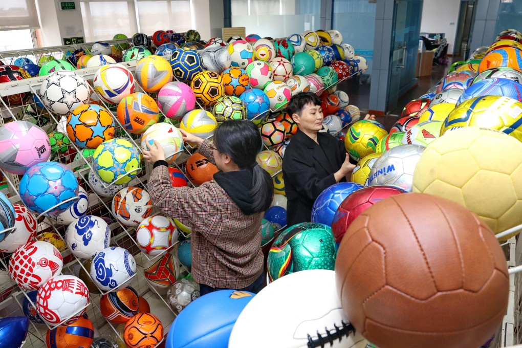 Workers check footballs at a factory in Nantong, Jiangsu province, in 2022. Photo: AFP