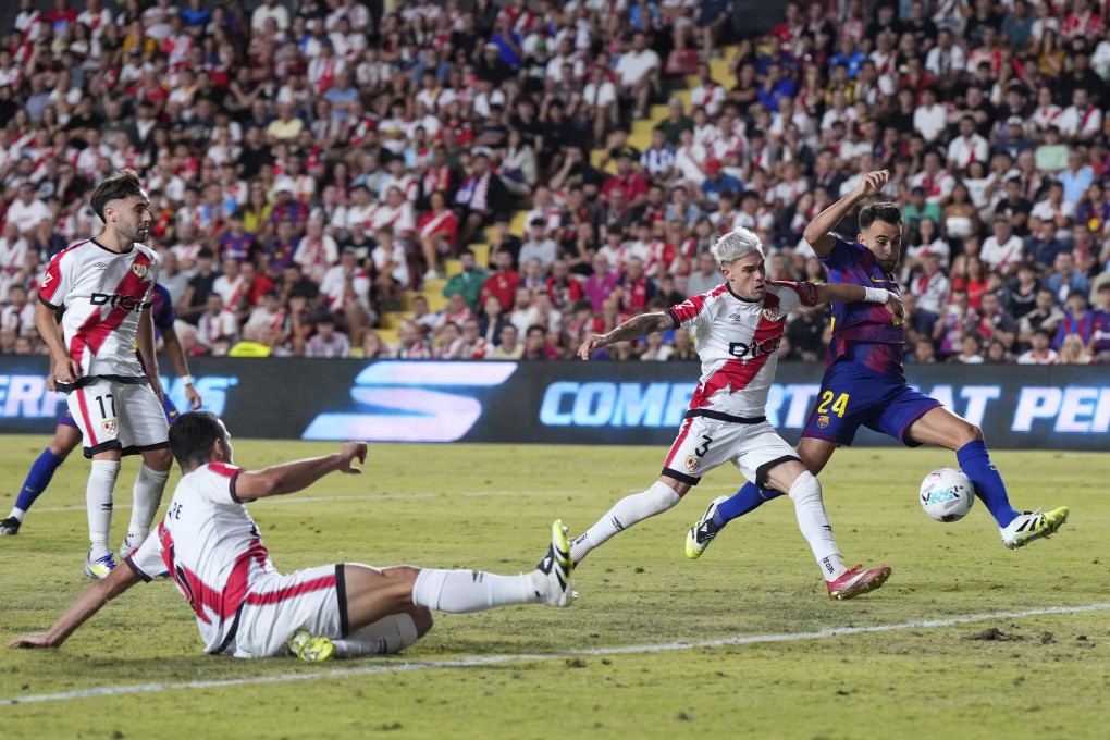 Barcelona (in blue and red) and Rayo Vallecano contest a La Liga match in Madrid last Sunday. Photo: AP